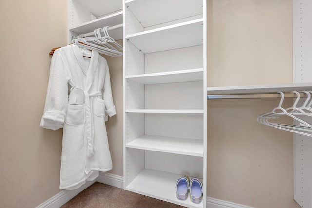 spacious closet featuring dark carpet