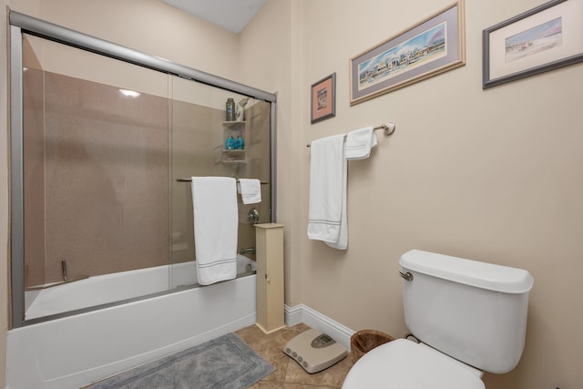 bathroom featuring toilet, enclosed tub / shower combo, and tile flooring