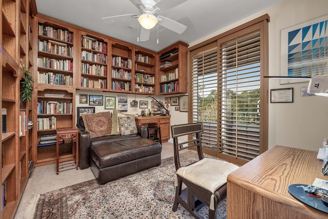 office featuring light colored carpet, ceiling fan, and built in features