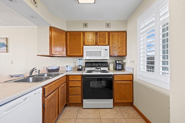 kitchen with white appliances, sink, and light tile flooring