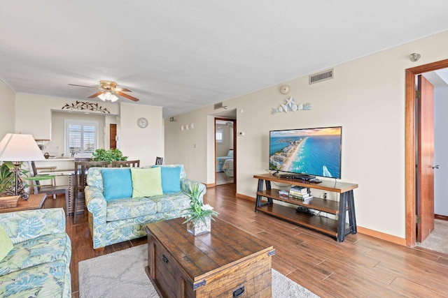 living room featuring ceiling fan and hardwood / wood-style flooring