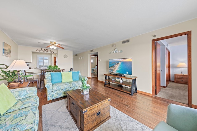 living room with hardwood / wood-style floors and ceiling fan