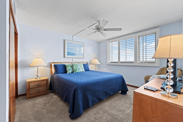 bedroom featuring a textured ceiling, ceiling fan, and carpet floors