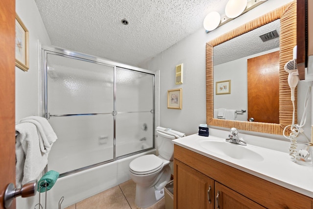 full bathroom featuring a textured ceiling, oversized vanity, combined bath / shower with glass door, and tile flooring