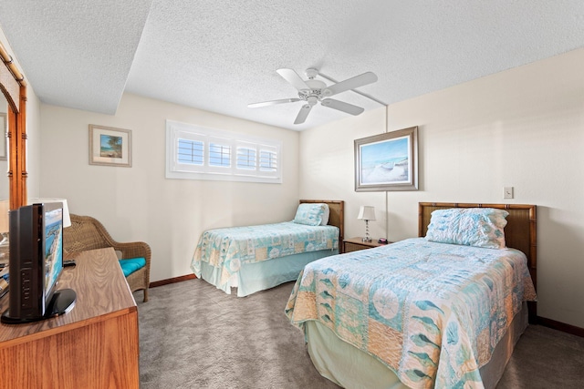 bedroom with a textured ceiling, ceiling fan, and dark colored carpet