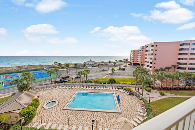 view of pool with a water view