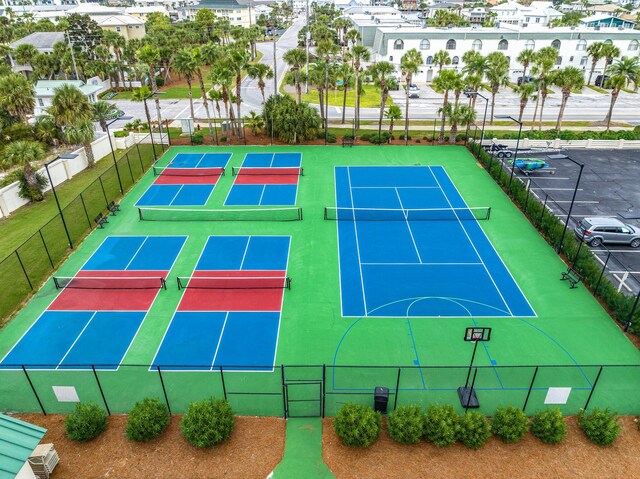 view of tennis court featuring basketball hoop