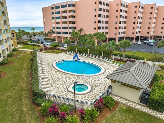 view of pool featuring a lawn