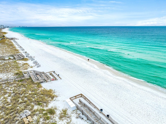 drone / aerial view featuring a water view and a beach view