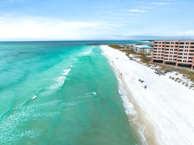 birds eye view of property featuring a beach view and a water view