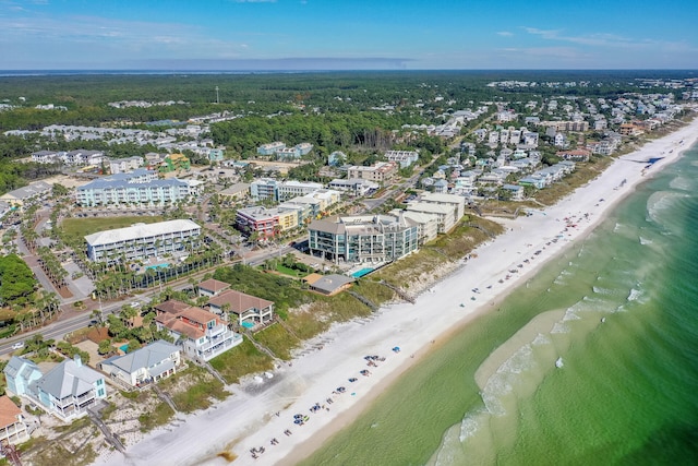 drone / aerial view featuring a beach view and a water view