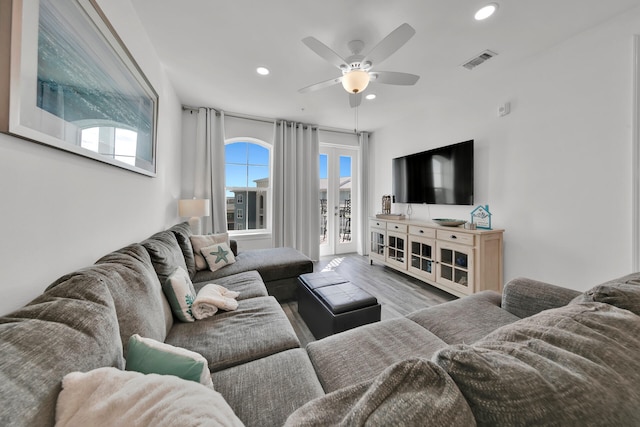 living room featuring ceiling fan and light wood-type flooring