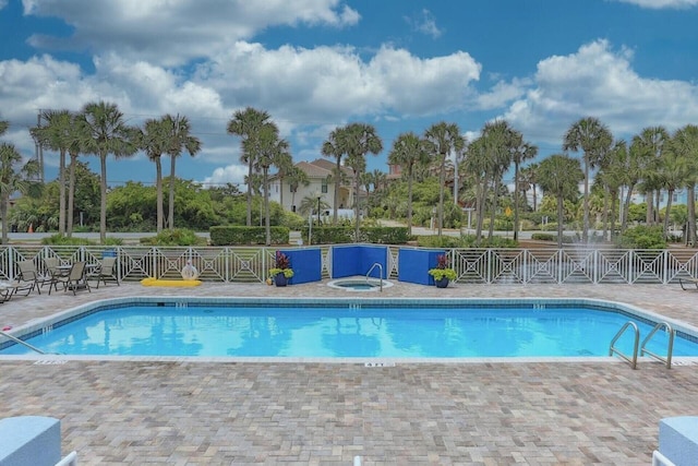 view of pool featuring a patio area and a community hot tub