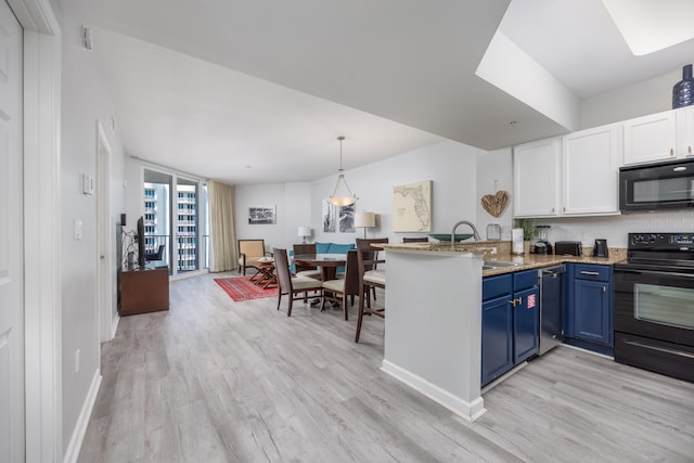 kitchen featuring black appliances, white cabinets, sink, blue cabinetry, and kitchen peninsula