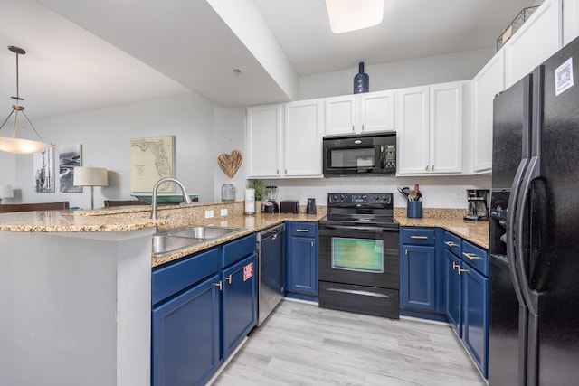 kitchen with kitchen peninsula, black appliances, decorative light fixtures, and blue cabinets