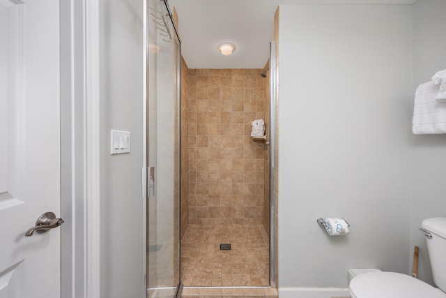 bathroom with an enclosed shower and toilet