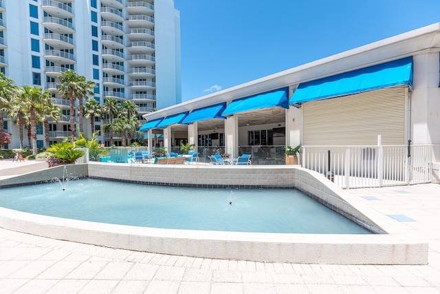 view of swimming pool with pool water feature