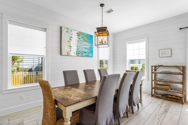 dining area featuring plenty of natural light, light hardwood / wood-style floors, and a notable chandelier