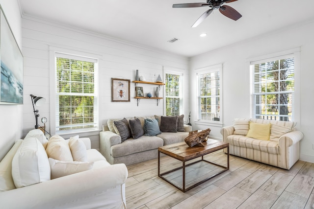 living room featuring a wealth of natural light, ceiling fan, and light hardwood / wood-style floors