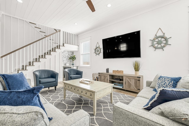 living room with ceiling fan, crown molding, and dark hardwood / wood-style flooring