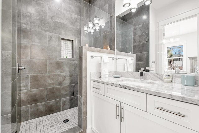 bathroom featuring vanity and tiled shower