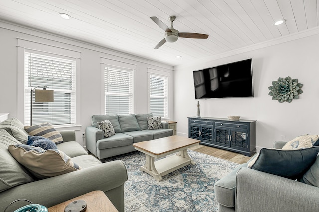 living room featuring ornamental molding, wooden ceiling, ceiling fan, and light wood-type flooring