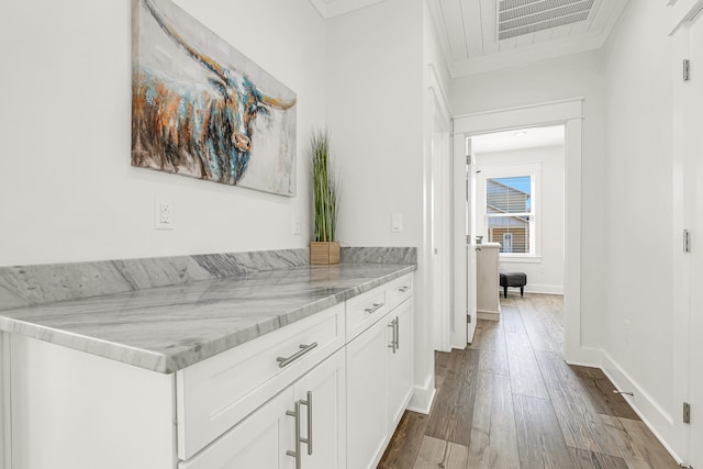 interior space featuring hardwood / wood-style floors, vanity, and crown molding