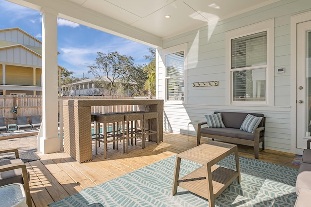 view of terrace with a deck and a bar