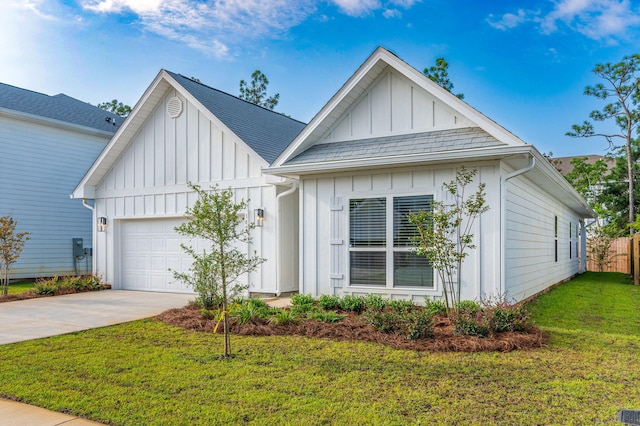 view of front of property featuring a garage and a front lawn