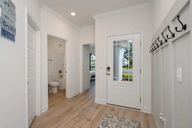 doorway to outside with crown molding and light hardwood / wood-style flooring