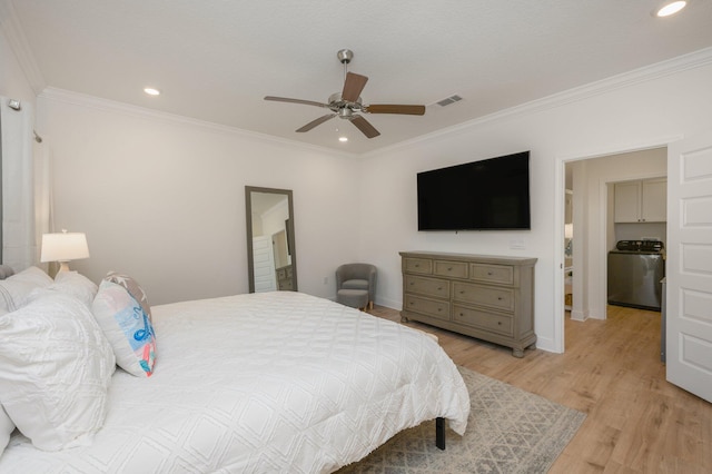 bedroom with ceiling fan, light hardwood / wood-style floors, washer / dryer, and ornamental molding