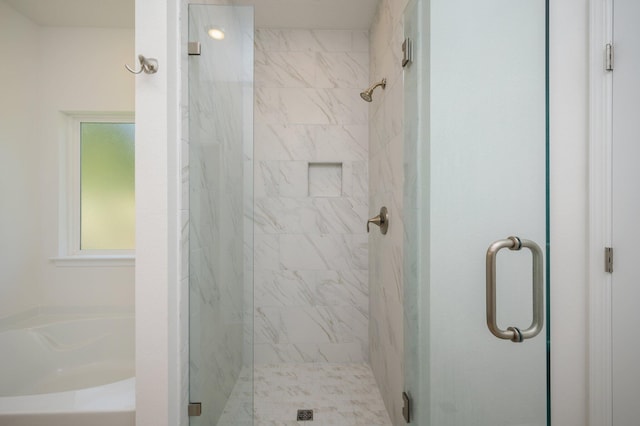 bathroom with separate shower and tub