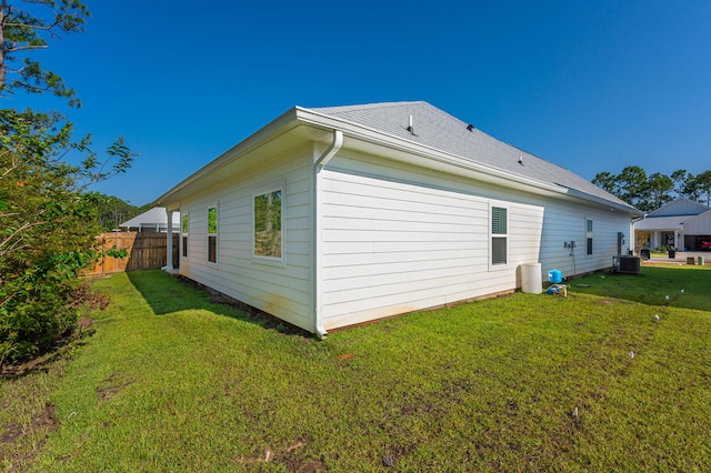 view of home's exterior with a yard and central AC