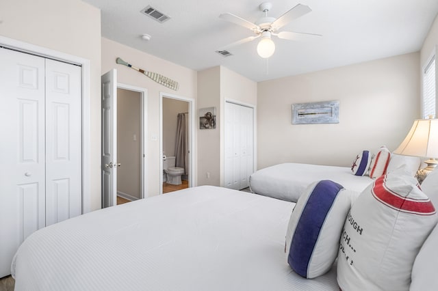 bedroom featuring multiple closets, ceiling fan, and ensuite bathroom