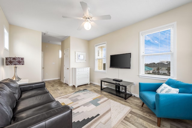 living room featuring light hardwood / wood-style flooring and ceiling fan