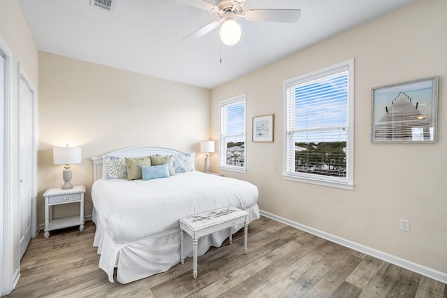 bedroom with light hardwood / wood-style flooring and ceiling fan