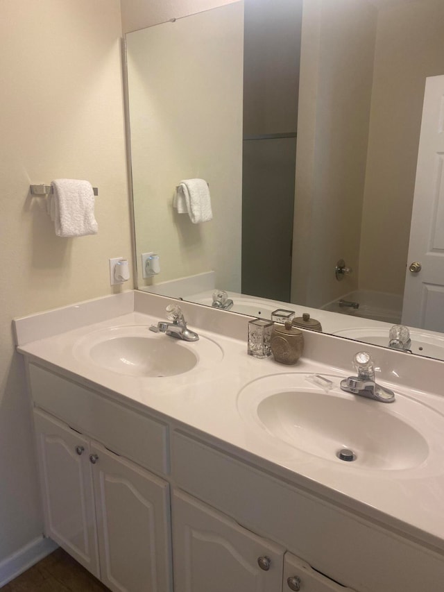 bathroom featuring dual sinks, tub / shower combination, and oversized vanity