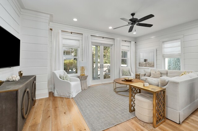 living room featuring french doors, light hardwood / wood-style floors, and ceiling fan