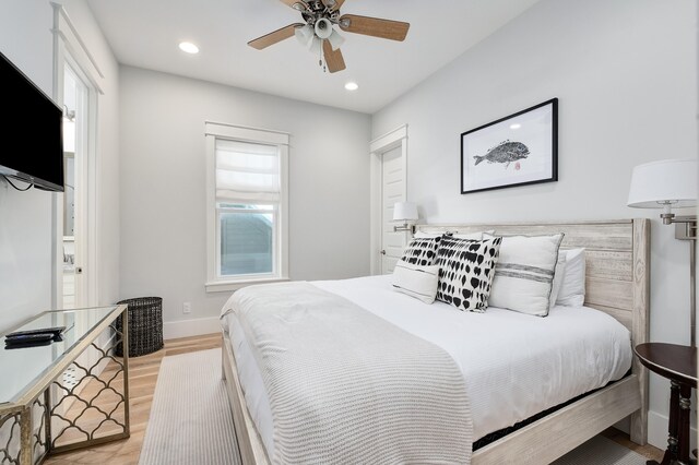 bedroom with ceiling fan and light wood-type flooring