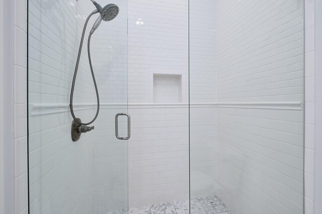 bathroom with a shower with door