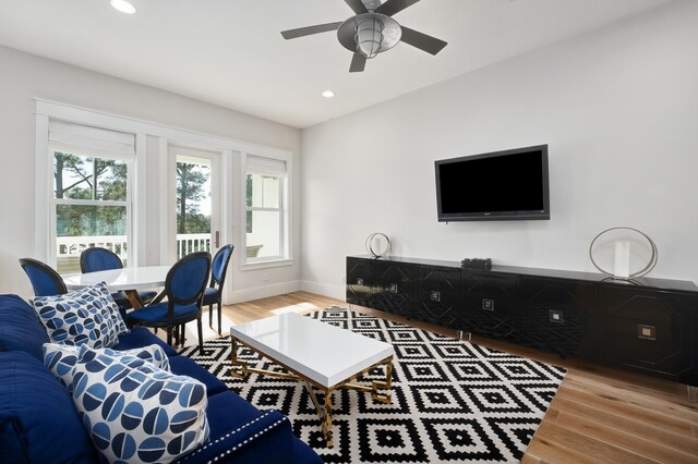 living room featuring ceiling fan and light wood-type flooring