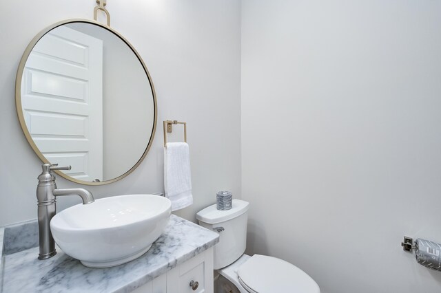 bathroom with toilet and vanity