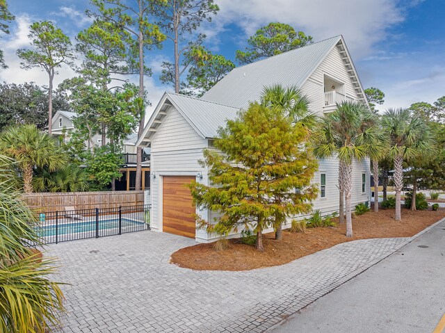 view of property exterior featuring a fenced in pool