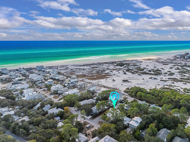 drone / aerial view featuring a beach view and a water view