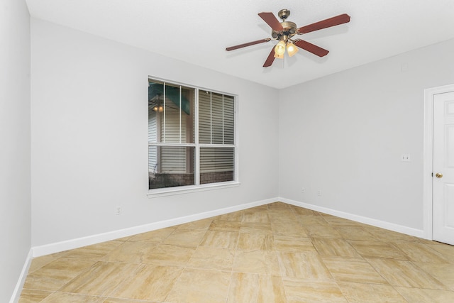 tiled empty room featuring ceiling fan