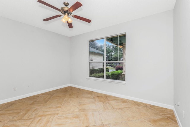 tiled empty room featuring ceiling fan