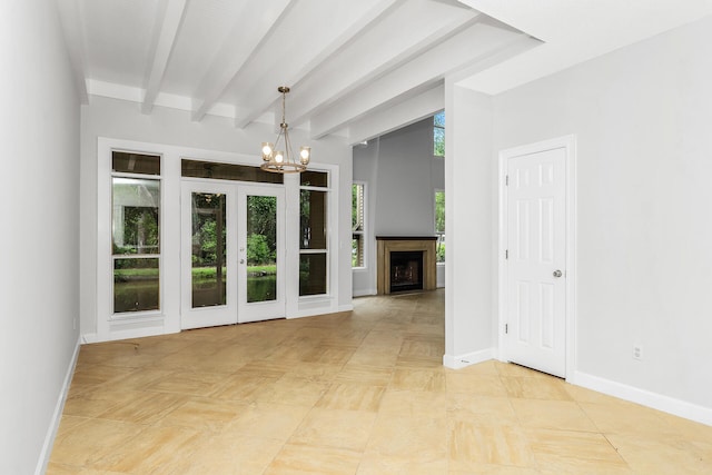 unfurnished living room featuring light tile flooring, beam ceiling, a chandelier, and french doors