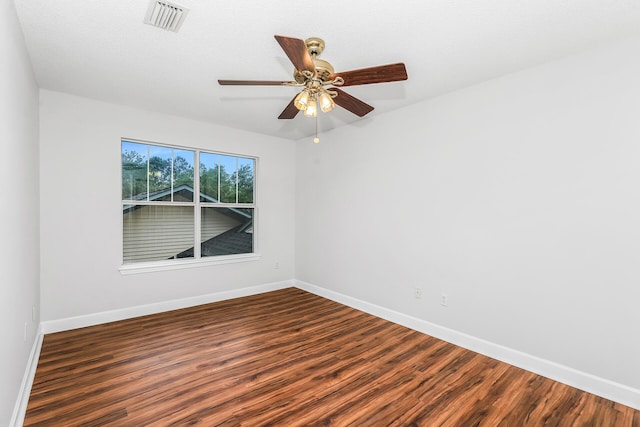 empty room featuring ceiling fan and dark wood-type flooring