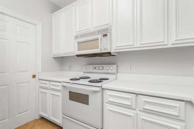 kitchen with white cabinets, white appliances, and light tile floors