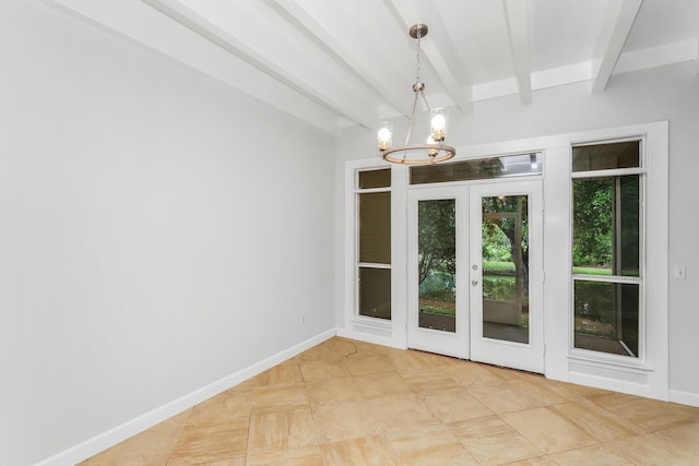 tiled spare room with beam ceiling, an inviting chandelier, and french doors